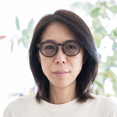 a woman wearing glasses and a white shirt