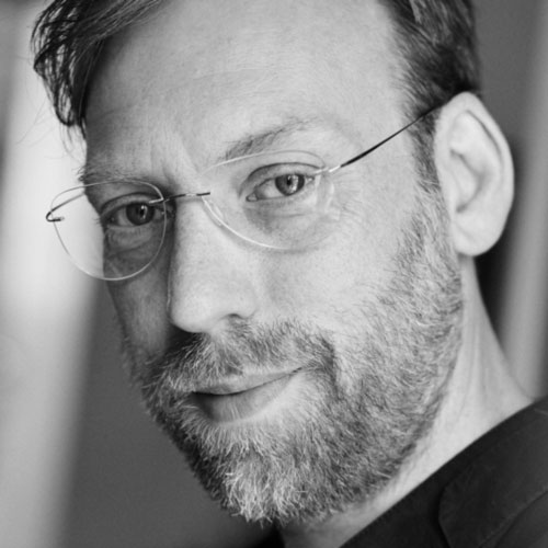 a black and white photo of a man with glasses