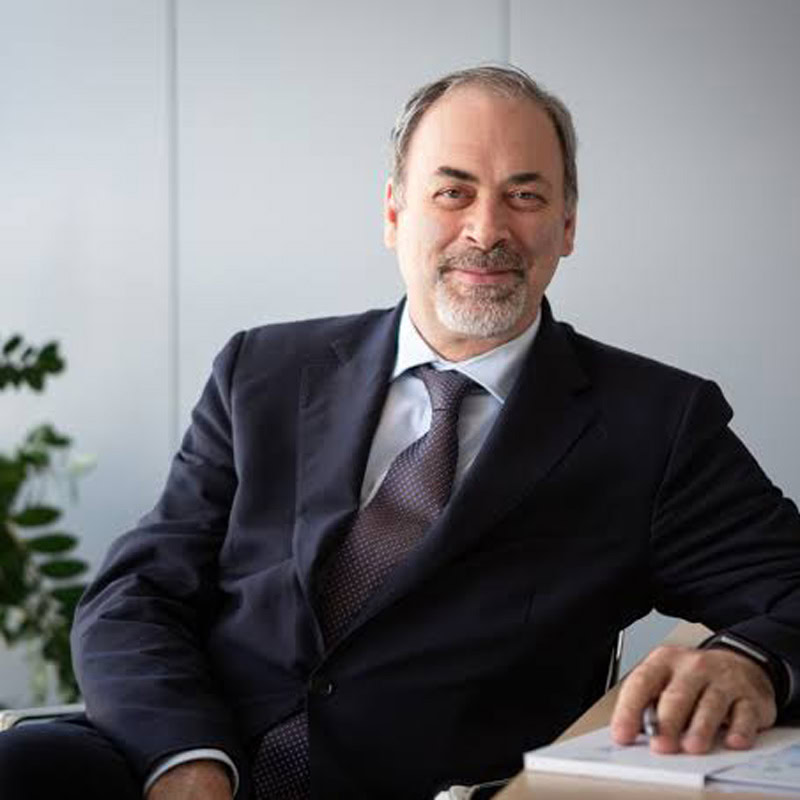 a man in a suit and tie sitting at a desk